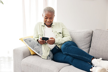 Image showing Happy black woman, smartphone and typing on sofa for social media post, digital contact and reading notification. Cellphone, mobile games and scroll online shopping app to search subscription at home