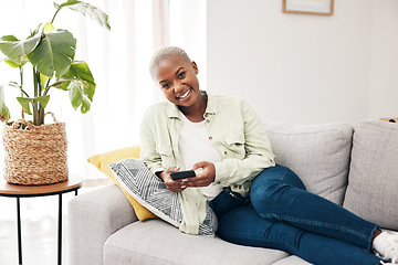 Image showing Portrait, woman and typing with phone on sofa for social media, chat and online notification at home. Happy african person relax with smartphone, download mobile games or scroll on digital multimedia