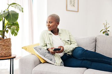 Image showing Woman, smile and thinking with smartphone on sofa for social media post, digital contact and user connection. Happy african person, mobile and idea to download app, search subscription or web at home