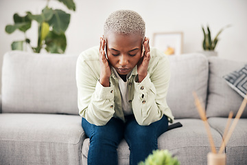 Image showing Anxiety, headache and pain with a black woman on a sofa in the living room of her home for mental health. Stress, burnout or vertigo and a young person in an apartment with depression or a migraine