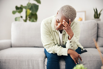 Image showing Woman, depression and headache in home for anxiety, mental health and stress of mistake, debt or crisis. Tired, sad and frustrated african person with emotional trauma, broken heart and worry on sofa