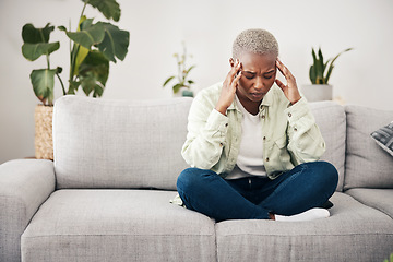 Image showing Stress, headache and burnout with a black woman on a sofa in the living room of her home for mental health. Anxiety, pain or vertigo and a young person in an apartment with depression or a migraine