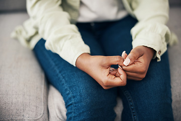 Image showing Anxiety, hands and woman on a sofa with stress, worry or mental health crisis in her home. Depression, trauma and zoom on female with bipolar, fear or abuse, danger or nervous nail picking habit