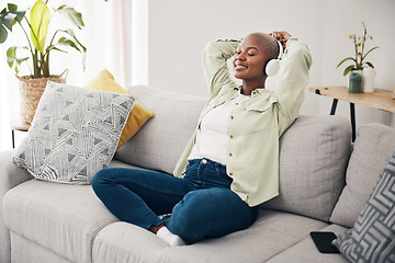 Image showing Black woman, meditation and listening to podcast to relax with headphones in home, living room or peace on sofa. Music, tech or happiness on face of person with calm, mindset or wellness in apartment