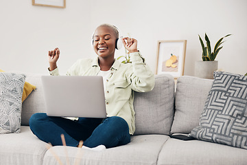 Image showing Laptop, music and black woman dance on a sofa with headphones, free and happy in her home. Podcast, earphones and African female dancing to feel good radio, audio or album playlist in a living room