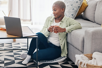 Image showing Woman, coffee and watch movies on laptop, streaming multimedia or news show on floor of home. Happy african person relax with cup of tea, computer or social media subscription of online entertainment