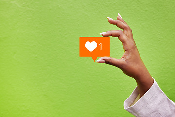 Image showing Hand, heart and like emoji with a person on green background mockup in studio for social media. Banner space, icon and post with an adult holding a logo closeup for communication or networking