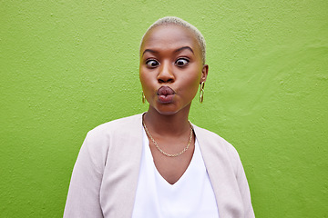 Image showing Happy, silly and young black woman by a green wall with trendy, classy and elegant jewelry and outfit. Happiness, goofy and African female model with positive and confident attitude with fashion.