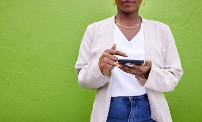 Image showing Hands, internet and phone for communication by a wall or green background for connection. Closeup of a woman with a smartphone for social media search, networking and mobile app chat or mockup space