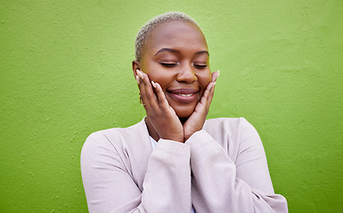 Image showing Happy, black woman and self love or stylish on a green wall for fashion, thinking or trendy. Smile, young and a calm African girl or fun model with confidence, fashion or peace on a background