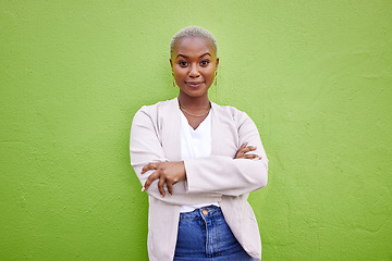 Image showing Portrait, fashion and happy black woman with arms crossed on green wall background mockup space. Positive designer, smile and confident African person in style, casual clothes and trendy in Nigeria