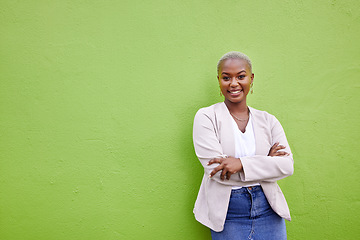 Image showing Portrait, fashion and black woman smile with arms crossed on green wall background mockup space. Positive designer, happy and confident African person in style, casual clothes and trendy in Nigeria