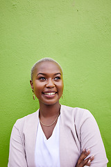 Image showing Happy, crossed arms and young black woman by a green wall with classy and elegant jewelry and outfit. Happiness, smile and African female model with positive and confident attitude with mockup space.