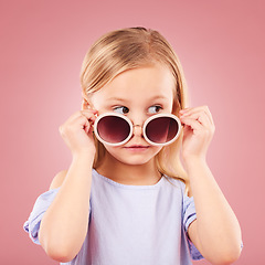 Image showing Curious, face and girl child with glasses in studio with news, announcement or promo on pink background. Interesting, information and kid hearing gossip, story or secret, rumor or watching drama