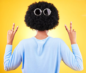 Image showing Peace sign, sunglasses and afro of black woman for fashion in studio isolated on a yellow background. V hand, glasses on hair and back of African person for style, cool and funny emoji for victory