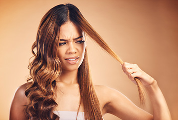 Image showing Hair, problem and women with crisis and frustrated from salon treatment and Brazilian fail. Studio, brown background and angry model with damage from split ends and upset of bad and messy haircut