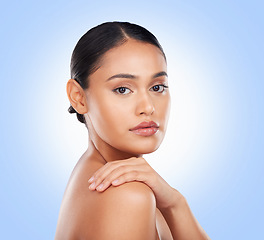 Image showing Portrait, glow and a woman with skincare on a blue background for wellness, beauty and health. Moisture, natural and a girl or model touching skin for cosmetics, dermatology or grooming on a backdrop