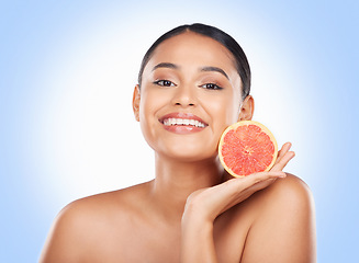 Image showing Beauty skincare, portrait and happy woman with grapefruit treatment results, natural self care or fruit benefits. Vitamin C product, eco friendly cosmetics or studio face of person on blue background