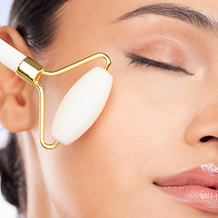 Image showing Woman, face roller and closeup for beauty, healthy skincare benefits and aesthetic dermatology. Model, crystal cosmetics product and facial massage tools for lymphatic drainage, collagen and shine