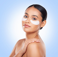 Image showing Woman, eye patch and beauty, skincare in portrait with facial isolated on blue background. Face mask, cosmetic product and wellness, dermatology and skin glow with treatment and self care in studio