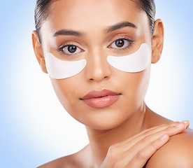 Image showing Skincare, portrait and woman with collagen patch for anti aging luxury skin glow on blue background. Cosmetics, facial detox and face of model with solution or eye product for dermatology in studio.