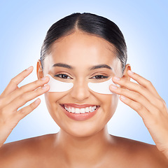 Image showing Skincare, eye mask and portrait of happy woman with collagen pad for anti aging skin glow on blue background. Cosmetics, facial beauty and face of model with patches or mask for dermatology in studio