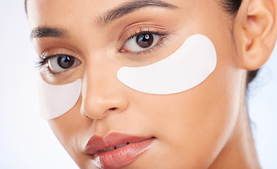 Image showing Portrait, skincare and woman with eye patch for anti aging or skin glow for beauty on studio background. Cosmetics, facial detox and face of model with pads or collagen mask for dermatology product.