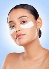 Image showing Eye patch, woman and portrait for skincare and face health, dermatology and self care shine in studio on blue background. Beauty, person and facial product with collagen mask, wellness and glow