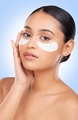 Image showing Eye patch, skincare and woman with portrait and face health, dermatology and self care shine in studio on blue background. Beauty, person and facial product with collagen mask, wellness and glow