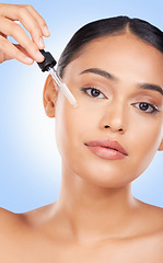 Image showing Woman, face and oil serum, beauty and skincare with liquid collagen isolated on blue background. Natural cosmetics, wellness and portrait, dermatology with pipette and hyaluronic acid in a studio