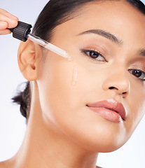 Image showing Woman, portrait and oil serum for skincare, cosmetics and beauty product on a white background. Young person with facial liquid, dermatology dropper or collagen for skin care health on face in studio