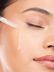 Image showing Face, essential oil and woman in studio for skincare, wellness or serum and cosmetic application. Beauty, facial and female model with hydration, vitamin c or retinol, hyaluronic acid or skin primer