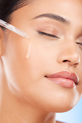 Image showing Face, oil and woman in studio for skincare, wellness or hydration, serum or cosmetic application. Beauty, facial and female model with hydration, vitamin c or retinol, hyaluronic acid or skin primer
