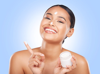 Image showing Portrait, happy woman and jar of face cream in studio, advertising lotion and glowing skincare on blue background. Model, facial beauty and container of moisturizer, sunscreen or cosmetic dermatology