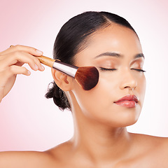Image showing Beauty, brush and young woman in studio for facial foundation, glamour and makeup treatment. Cosmetics, self care and Indian female model with cosmetology face product isolated by pink background.