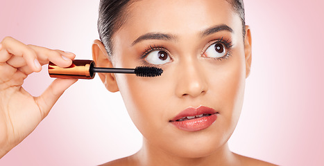 Image showing Beauty, woman and mascara for makeup and skincare, cosmetics and application in studio on pink background. Self care, person and brush for eyelash extension, product and aesthetic for volume