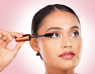 Image showing Makeup, woman and mascara for beauty and skincare, cosmetics and eyelash extension in studio on pink background. Self care, person and brush for application, product and aesthetic for volume