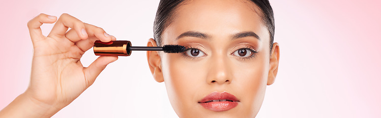 Image showing Woman, mascara and makeup, beauty and banner with transformation and cosmetic product on pink background. Eyelash extension, cosmetology and volume with brush in hand, wellness and change in a studio