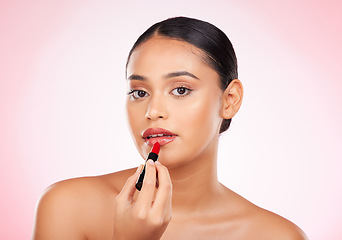 Image showing Woman, red and lipstick with beauty and makeup, cosmetics product in portrait isolated on pink background. Cosmetology, apply bold color to lips and shine, wellness and transformation in a studio