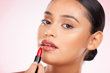 Image showing Beauty, makeup and red lipstick with portrait of woman in studio for cosmetics, glamour and product. Glow, self care and spa with face of person on pink background for salon, cosmetology and lip balm