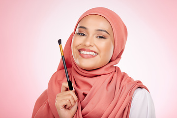 Image showing Portrait, beauty and muslim woman with makeup brush in studio for wellness and cosmetics on pink background. Halal skincare, face and female with hijab for luxury, glamour or Islamic safe products