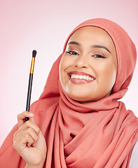 Image showing Portrait, happy and muslim woman with makeup brush in studio with cosmetic application on pink background. Halal, skincare and face of female model with beauty, tool or powder, luxury or satisfaction