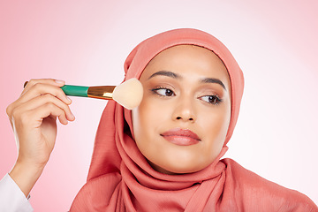 Image showing Makeup, foundation brush and muslim woman with self care from cosmetics and blush in studio. Facial, glow and relax female person with beauty, skincare and shine with a hijab and skin tool for face