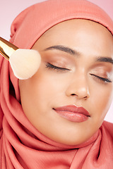 Image showing Makeup brush, relax and muslim woman closeup with a smile from cosmetics and blush in studio. Facial, glow and happy female person with beauty, skincare and shine with a hijab and skin tool for face