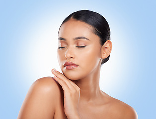 Image showing Skincare, beauty and woman with cosmetics, wellness and dermatology on a blue studio background. Self care, person or model with luxury, cosmetology or facial with aesthetic, grooming or healthy skin