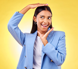 Image showing Happy, business and hands of woman frame face in studio yellow background for creative perspective or unique thinking. Indian model, hand and entrepreneur with idea for corporate startup in Mumbai