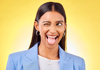 Image showing Funny, business woman and crazy worker with silly and tongue out in a studio. Happy, female person and yellow background with emoji and comedy face of a employee with modern fashion and style