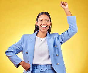 Image showing Fist, success and portrait of business woman in studio for pride, professional and champion. Empowerment, power and strong with person on yellow background for celebration, achievement and winner