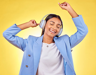 Image showing Dancing, fashion or happy woman streaming music in headphones on yellow background. Relax, smile or calm entrepreneur listening to radio song, album or audio sound on subscription playlist in studio