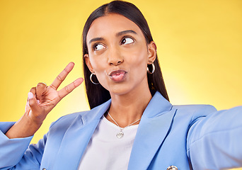 Image showing Business woman, peace sign and studio selfie with funny face, pouting and emoji by yellow background. Entrepreneur, hand and thinking with kiss, comic lips and icon for vote, social media or web blog